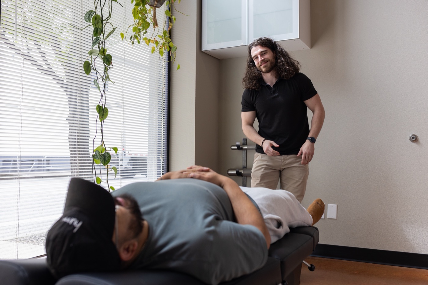 A doctor at Move Better working with a patient in the treatment room