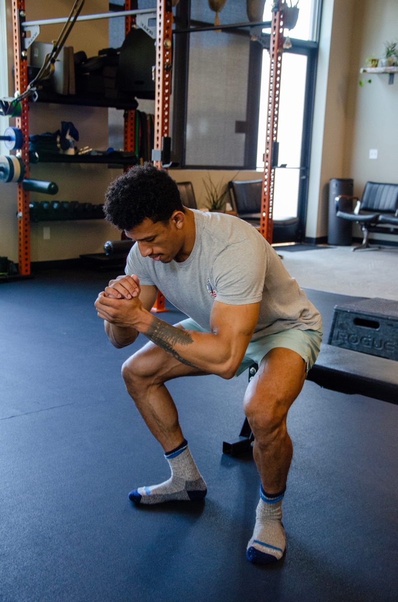A Move Better doctor coaching a patient through a hip hinge