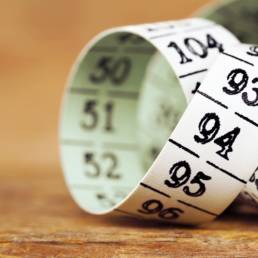 Weight loss, diet - measuring tape close-up